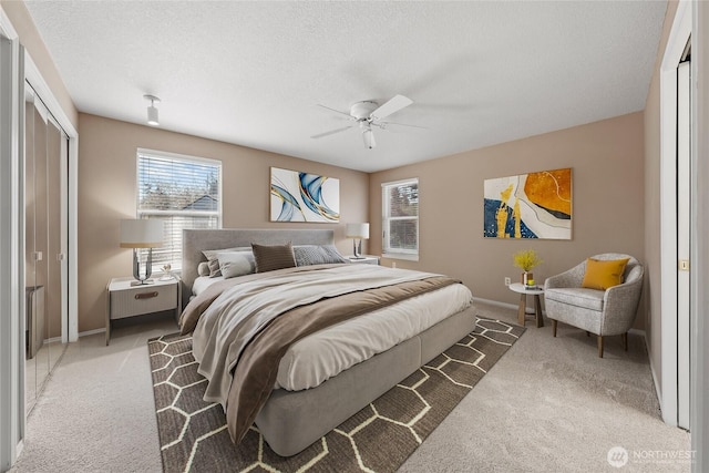 bedroom with carpet flooring, baseboards, and multiple windows