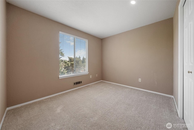 carpeted empty room with recessed lighting, baseboards, and visible vents