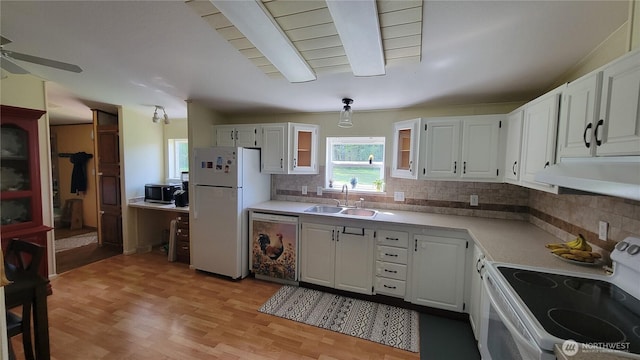 151 W Nikula Rd, Winlock, WA 98596 - kitchen featuring white appliances, under cabinet range hood, backsplash, a sink, and white cabinetry