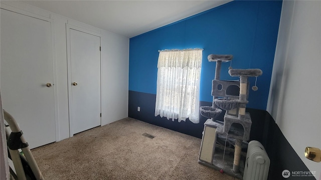 151 W Nikula Rd, Winlock, WA 98596 - carpeted bedroom featuring visible vents, radiator, and vaulted ceiling