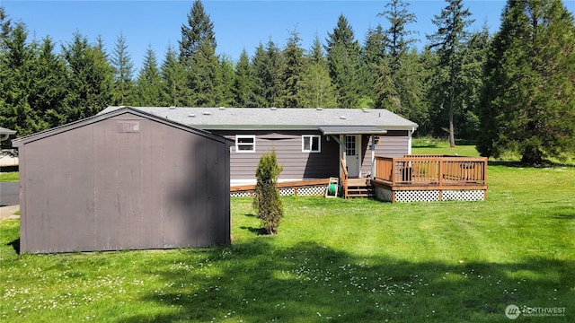 151 W Nikula Rd, Winlock, WA 98596 - rear view of house with a lawn, a forest view, and a wooden deck