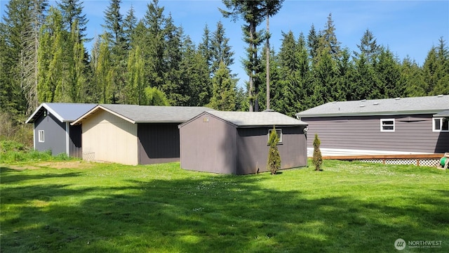 151 W Nikula Rd, Winlock, WA 98596 - rear view of property with a deck, an outdoor structure, and a yard