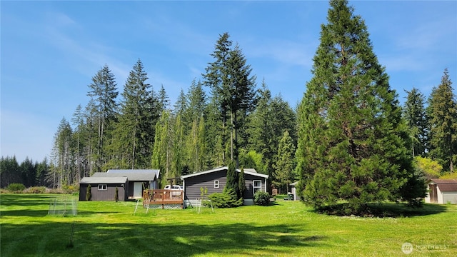 151 W Nikula Rd, Winlock, WA 98596 - view of yard featuring a wooden deck, an outbuilding, and a forest view