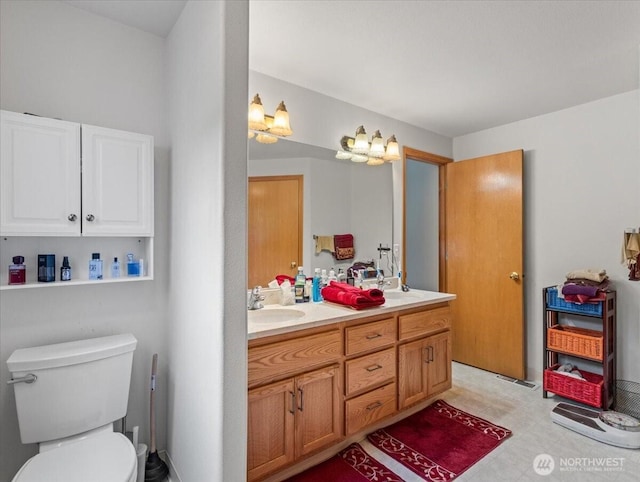 full bathroom with double vanity, toilet, tile patterned floors, and a sink