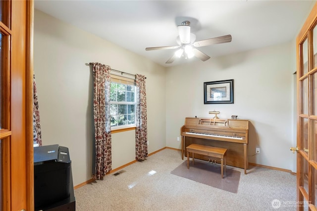 living area featuring carpet floors, a ceiling fan, baseboards, and visible vents
