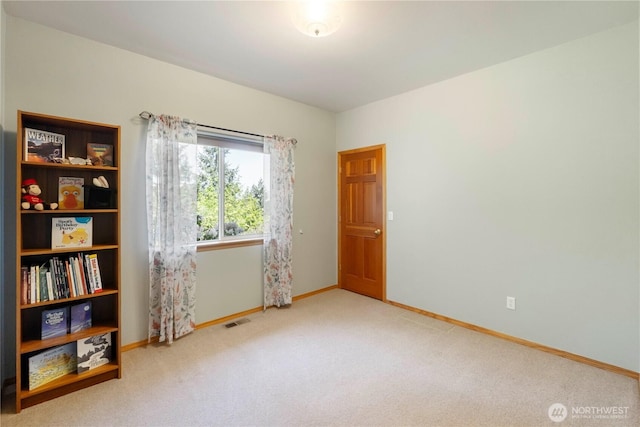 carpeted empty room with baseboards and visible vents