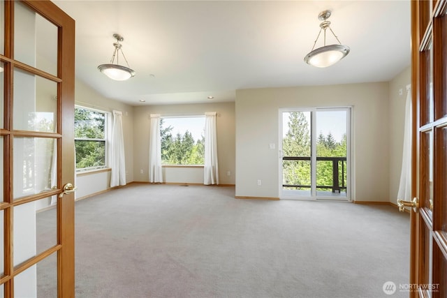 unfurnished room featuring baseboards and light colored carpet