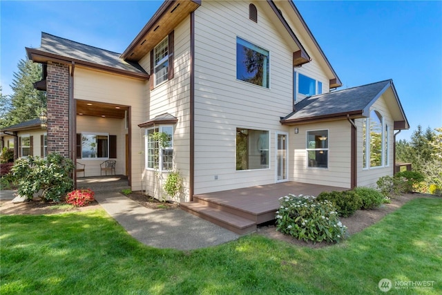 back of house with a lawn and a wooden deck