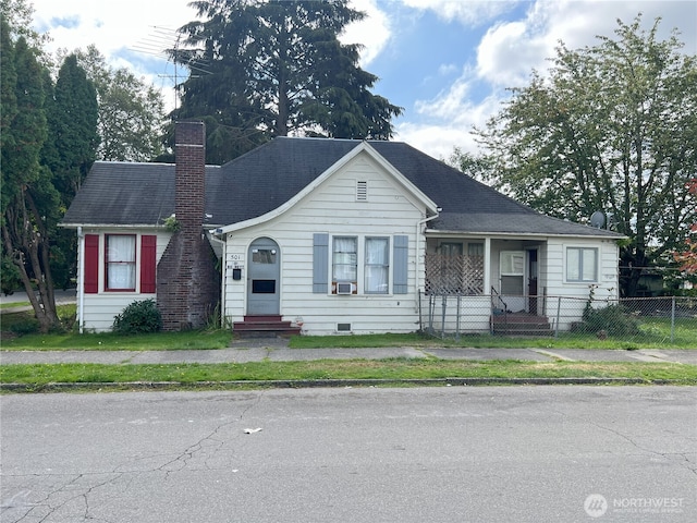view of front of home featuring cooling unit, fence, entry steps, and a chimney
