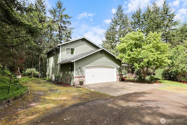 view of property exterior featuring concrete driveway, an attached garage, and brick siding