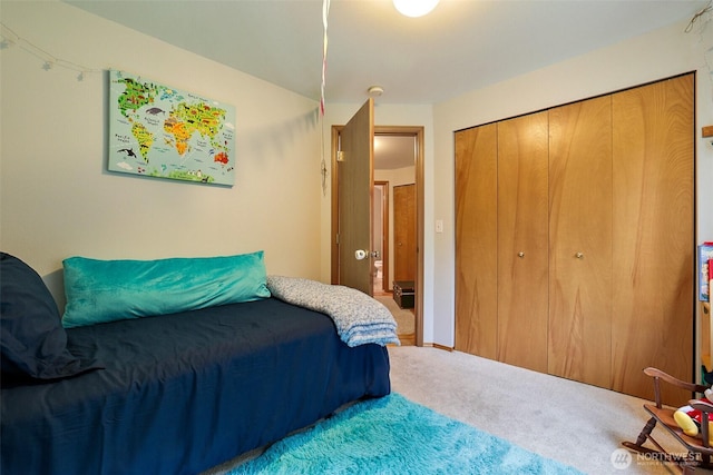bedroom with carpet and a closet