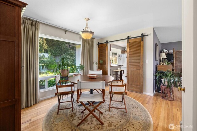 330 15th St, Snohomish, WA 98290 - dining room with a barn door, light wood finished floors, and baseboards