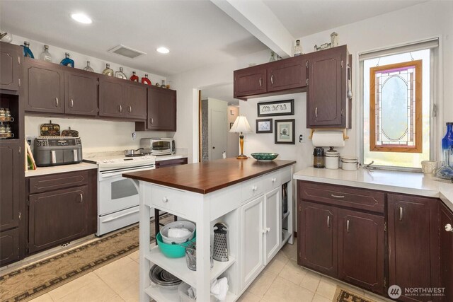 330 15th St, Snohomish, WA 98290 - kitchen with electric stove, open shelves, light tile patterned flooring, dark brown cabinetry, and recessed lighting