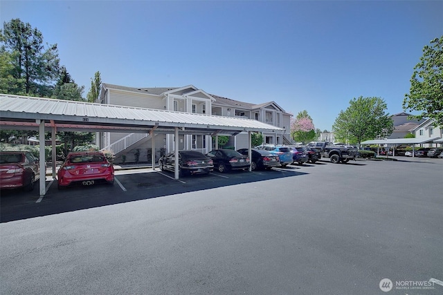 covered parking lot featuring stairway