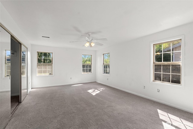 unfurnished bedroom with carpet, ceiling fan, and baseboards