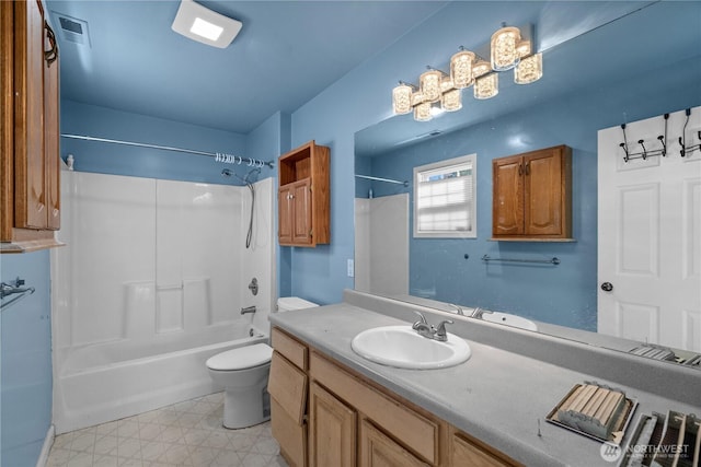 bathroom featuring vanity, tile patterned floors, toilet, visible vents, and bathtub / shower combination