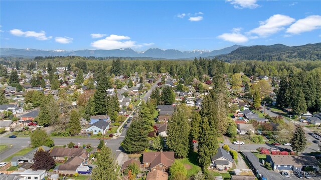 bird's eye view featuring a residential view, a mountain view, and a forest view