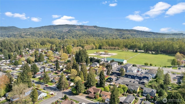 aerial view featuring a mountain view, a residential view, and a view of trees