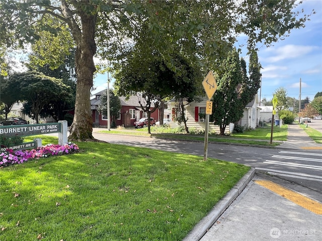 exterior space with curbs, sidewalks, and traffic signs