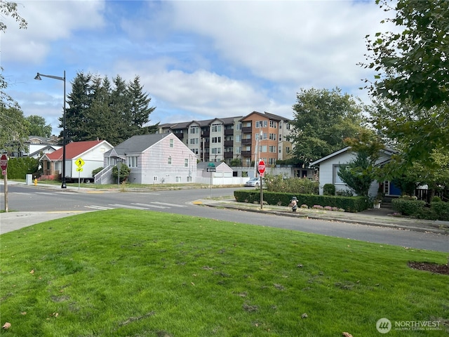 view of street featuring traffic signs, sidewalks, and curbs
