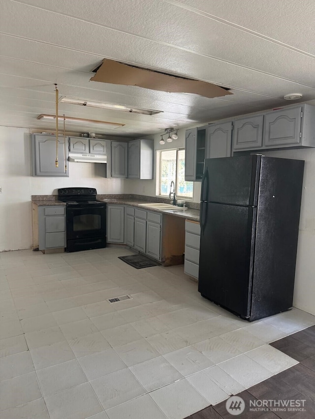 11316 SE 226th St, Kent, WA 98031 - kitchen featuring gray cabinets, under cabinet range hood, black appliances, a sink, and visible vents