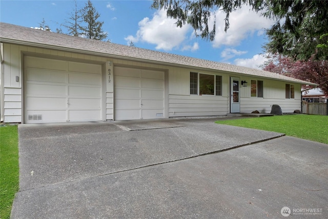 ranch-style home featuring an attached garage, a shingled roof, a front lawn, and concrete driveway