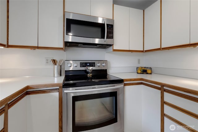 kitchen with light countertops, white cabinetry, and appliances with stainless steel finishes