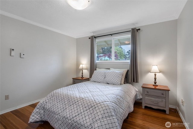bedroom featuring baseboards, crown molding, and wood finished floors