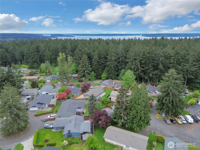 birds eye view of property featuring a view of trees and a residential view