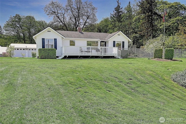 view of front of house with a chimney, a wooden deck, a front yard, and fence