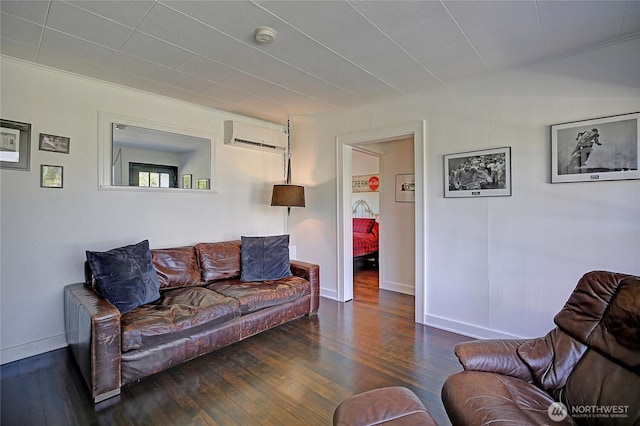 living area featuring baseboards, a wall mounted air conditioner, and wood finished floors