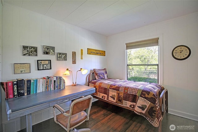 bedroom featuring baseboards and dark wood-style flooring
