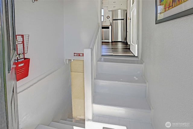 staircase featuring a textured wall