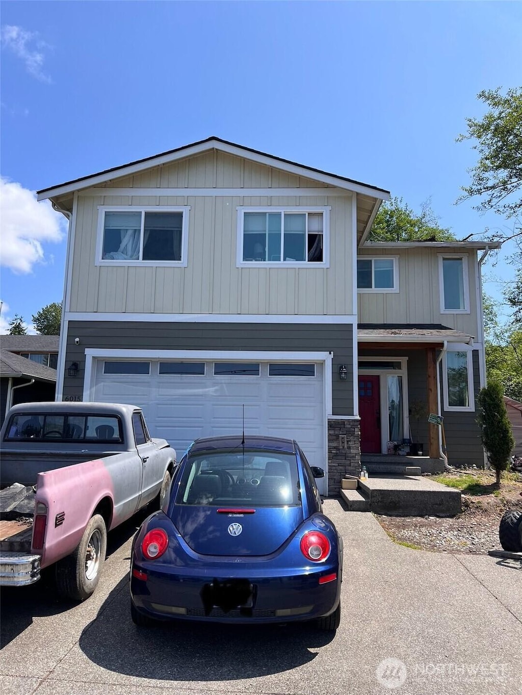 6015 67th Ave NE, Marysville, WA 98270 - view of front of property with asphalt driveway, a garage, and stone siding