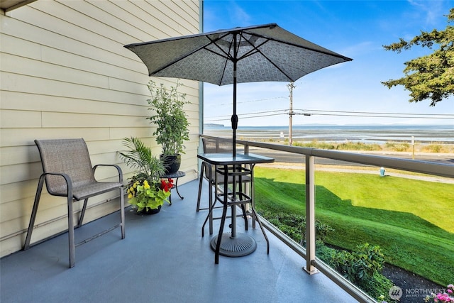 view of patio / terrace featuring a water view and a balcony