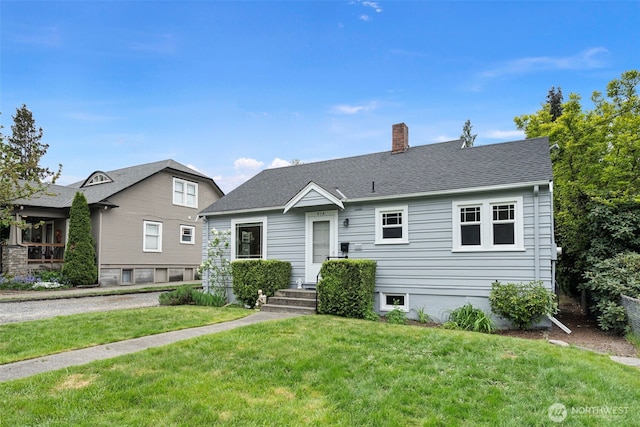 view of front of property with a chimney and a front yard