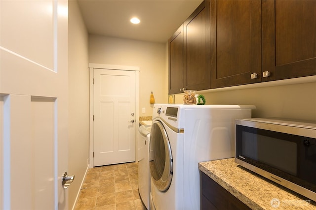 clothes washing area with stone finish floor, washing machine and dryer, cabinet space, baseboards, and recessed lighting