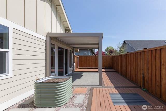 wooden terrace featuring a fenced backyard