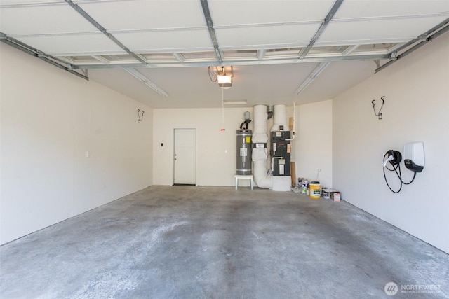 garage with a garage door opener, heating unit, and electric water heater