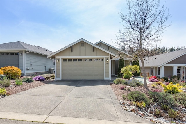ranch-style house featuring an attached garage, central AC unit, board and batten siding, and concrete driveway