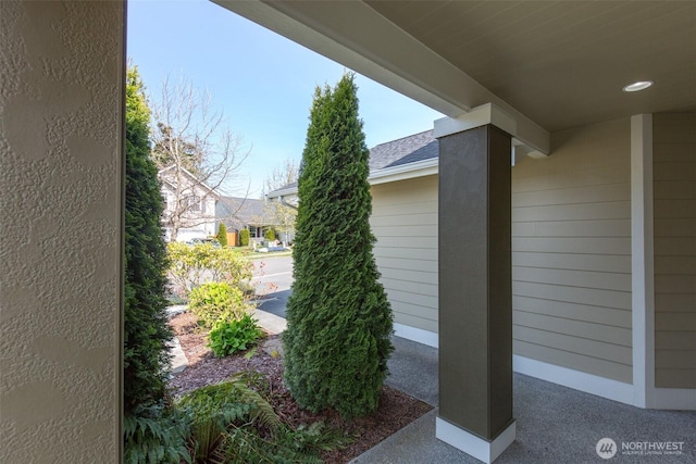 view of side of property with a shingled roof
