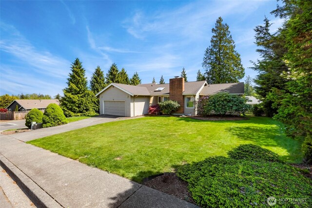 ranch-style house featuring a garage, a chimney, a front lawn, and aphalt driveway