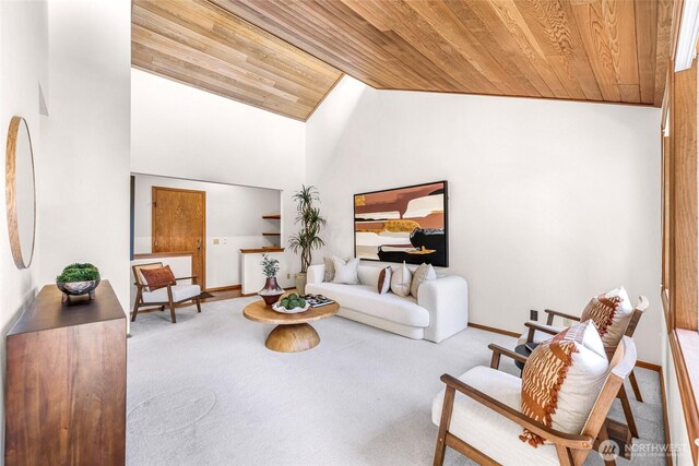 carpeted living room with baseboards, wooden ceiling, and lofted ceiling