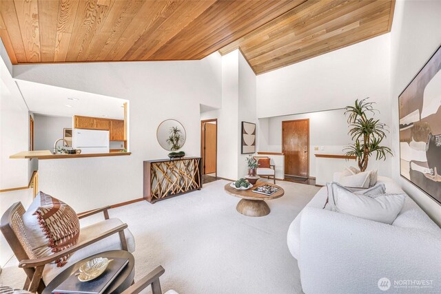 living area featuring wood ceiling, high vaulted ceiling, and carpet floors