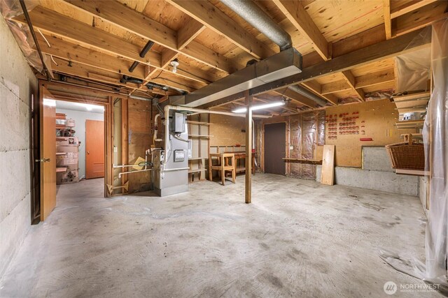 unfinished basement featuring heating unit