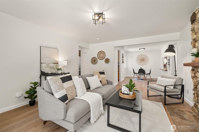 living room with light wood-type flooring and baseboards