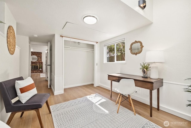 office area featuring baseboards, wood finished floors, and attic access