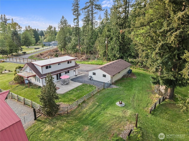 birds eye view of property with a wooded view