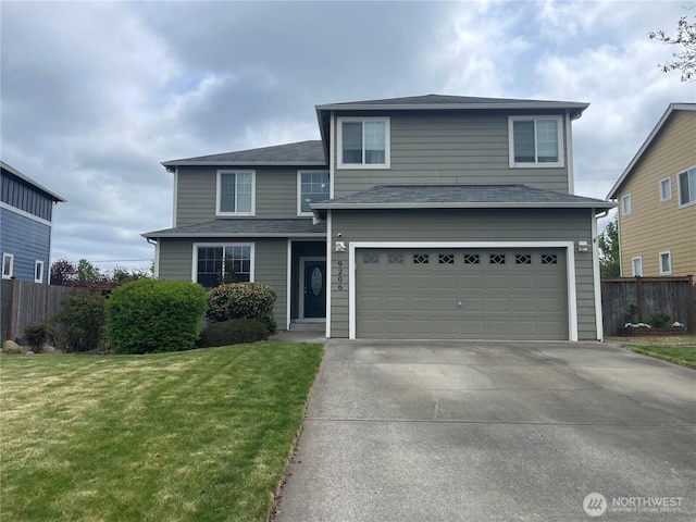 9206 Carys St SE, Yelm, WA 98597 - traditional-style house featuring driveway, fence, a front lawn, and a garage