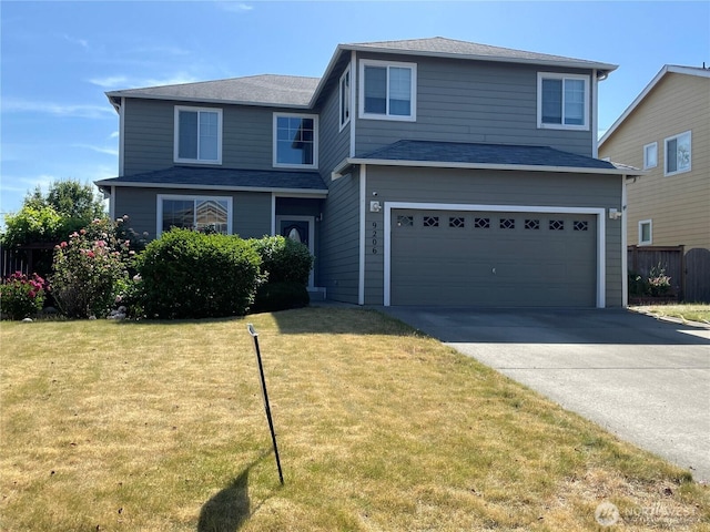 9206 Carys St SE, Yelm, WA 98597 - traditional-style home with concrete driveway, an attached garage, and a front yard